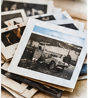 A stack of printed family and vehicle photographs